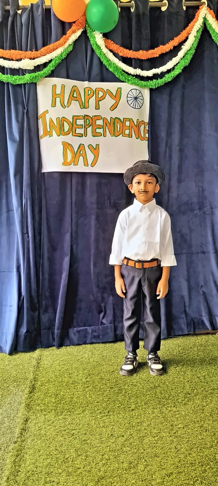 A boy with a painted moustache wearing a hat and white shirt