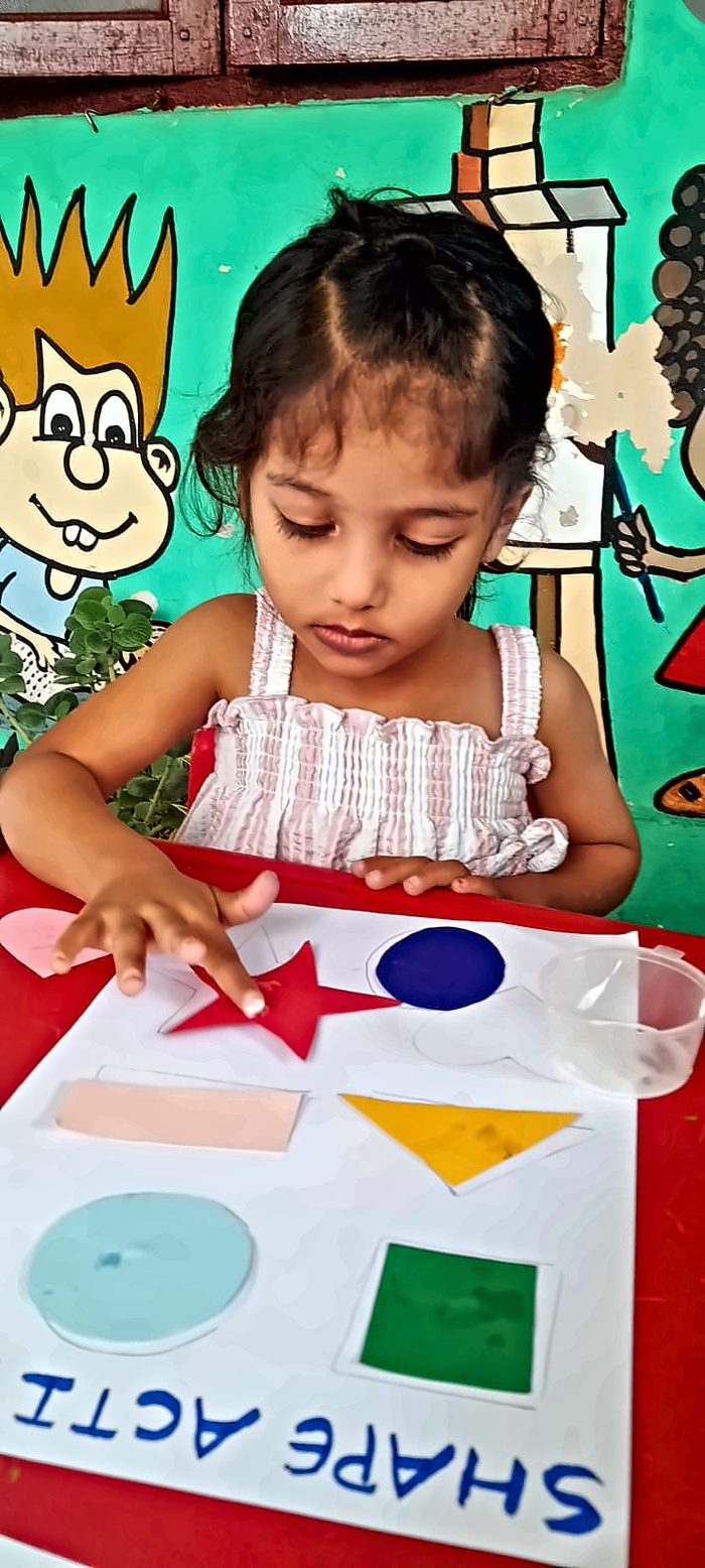 A girl concentrating on a shape-matching activity board