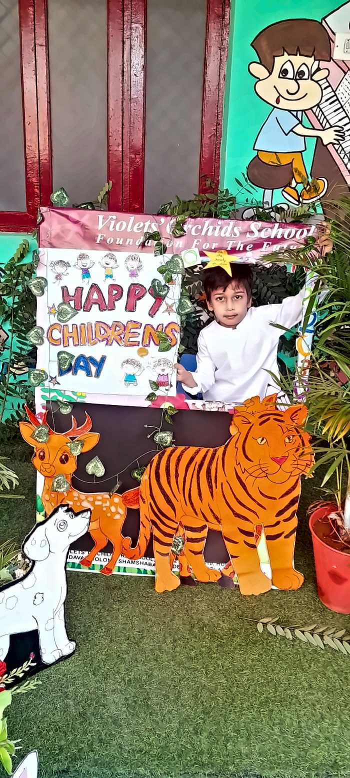 A boy at a Happy Children's Day photo booth with a painted tiger cutout